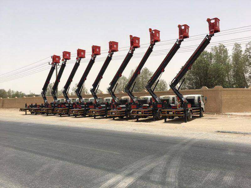 A fleet of 20 m aerial work platforms lined up after build-up and paint A fleet of 20 m aerial work platforms lined up after build-up and paint
