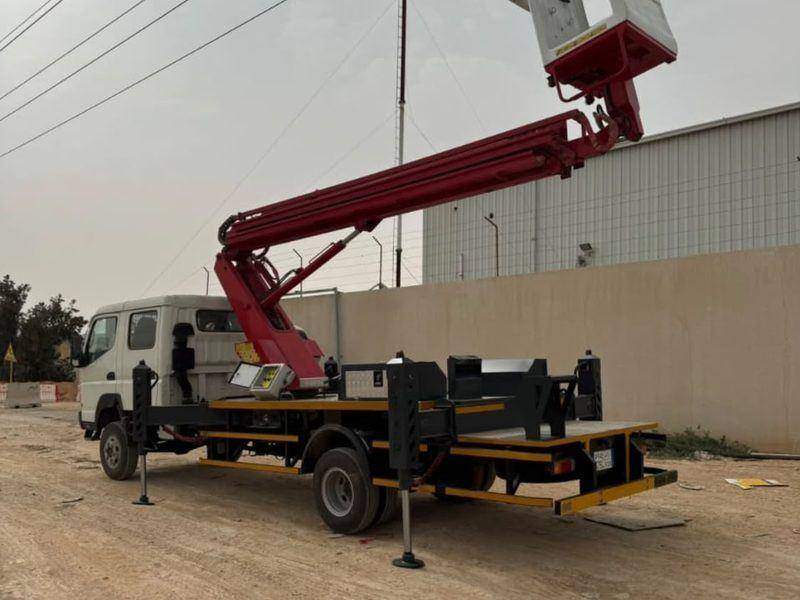 Aerial work platform with a maroon boom built on a medium-duty truck