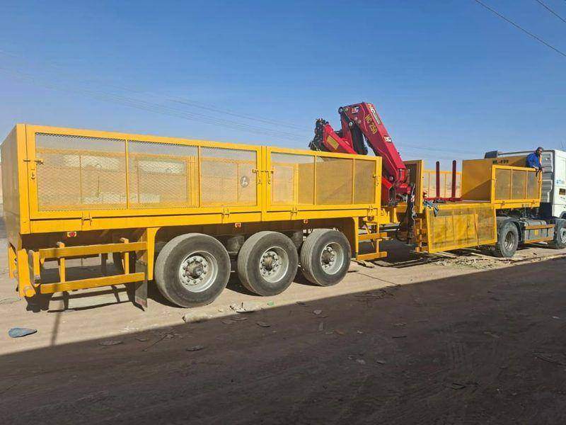 Semi-trailer with mesh sides and a rear-mounted knuckle crane, fully fabricated