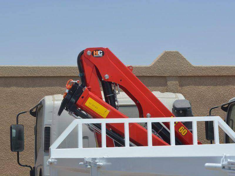 Knuckle boom crane mounted on a truck with a cab protection rack