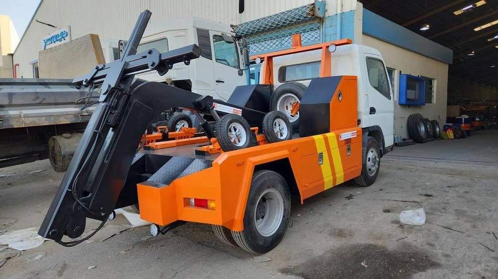 Recovery wrecker with a hydraulic tow boom equipped for vehicle recovery