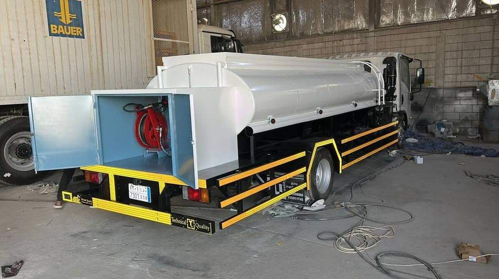 Water tanker on a truck with a hose reel and side equipment locker
